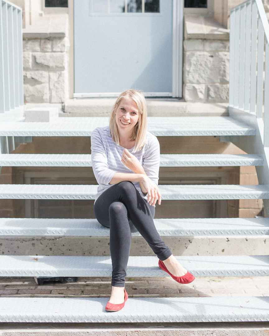 Ottawa photographer sits on stairs and smiles
